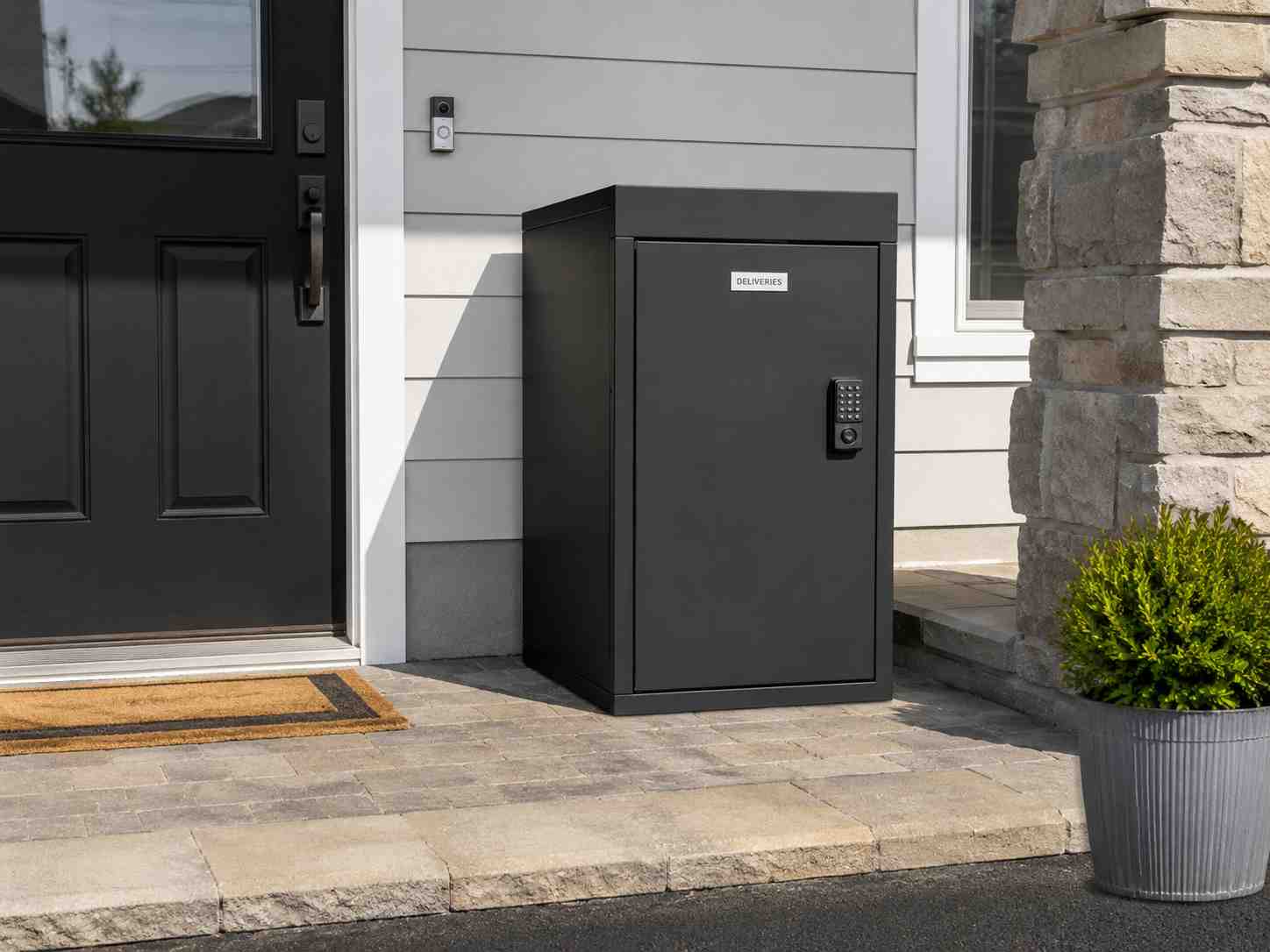 Lockable parcel delivery box mounted beside a front door to secure packages from theft