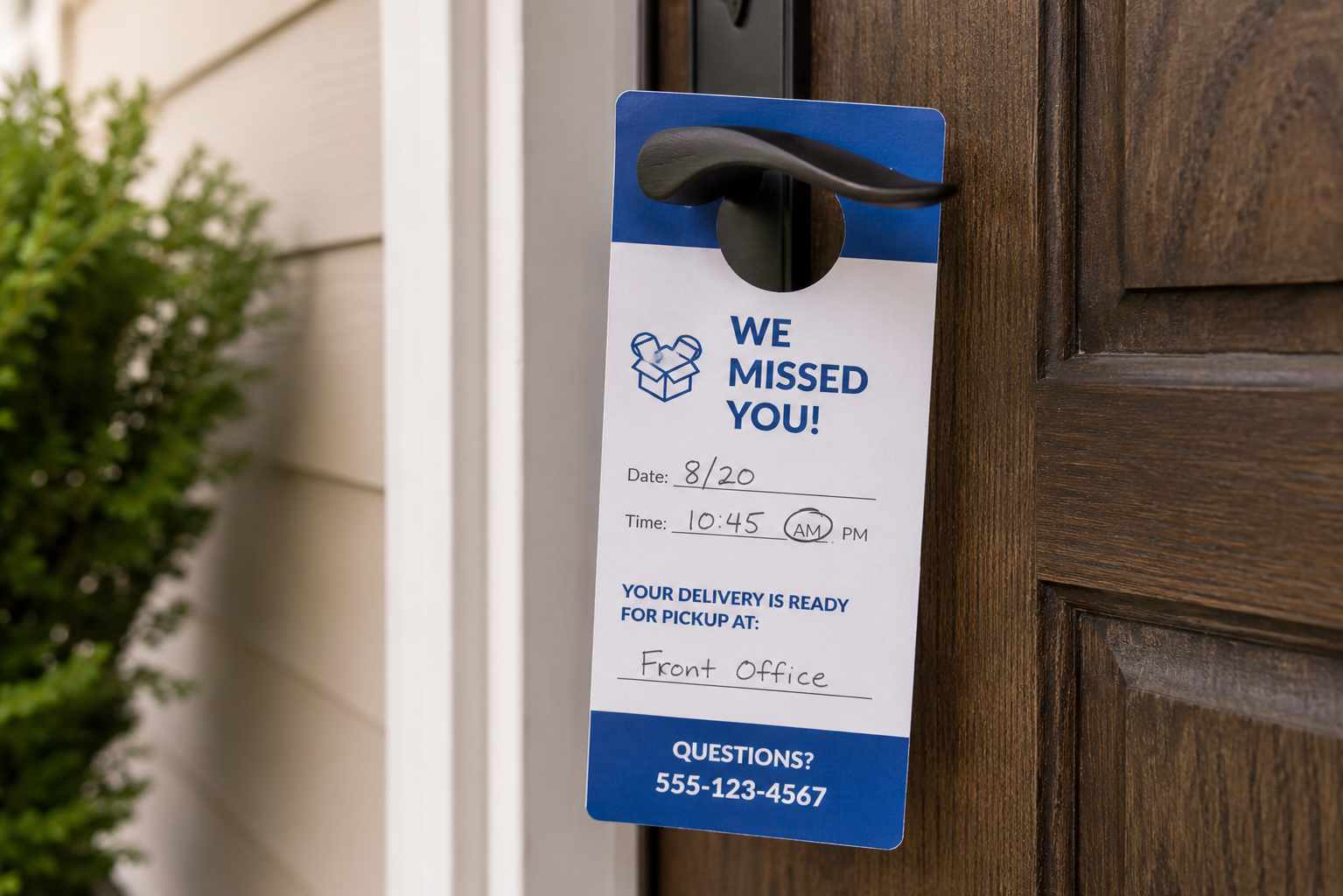 Delivery notice tag hanging on a front door handle
